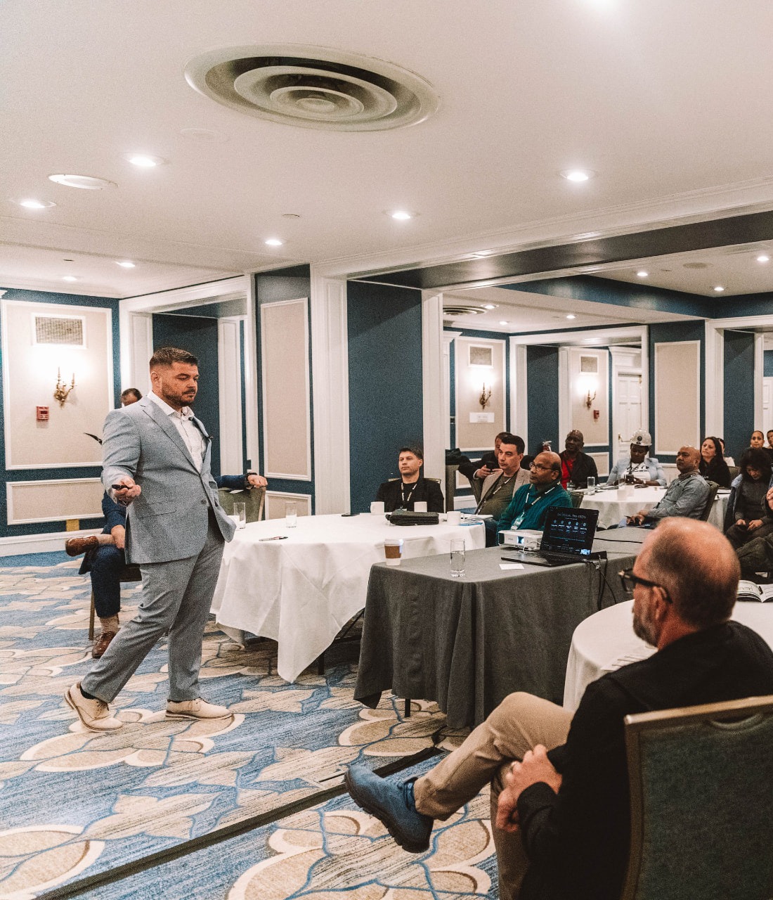 Yiannis on stage speaking to a business audience